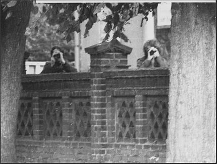 Fotodokumentation der Überwachung des Pfarrers Freimark, o.D. Pfarrer Freimark sowie eine männl. Person fotografieren die Absicherungskräfte